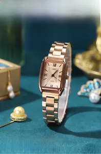 Detail view of rose gold rectangular watch with textured dial and Roman numerals