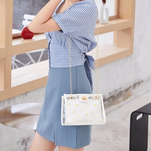 Transparent PVC crossbody bag with white daisy print and golden chain strap for women