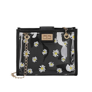 Transparent daisy print crossbody bag with black trim and gold chain strap in a main view
