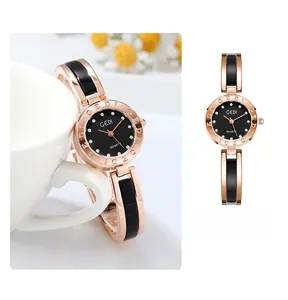 Detail of rose gold quartz watch with rhinestones on dial and black ceramic band