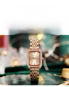 Close-up of GEDI women's square watch with green dial and rose gold steel strap