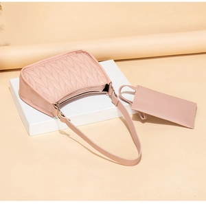Detail view of pink chevron quilted shoulder bag set with matching small coin purse