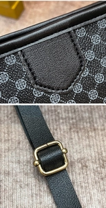 Detail of printed crossbody bag showing clover pattern texture and golden metal buckle