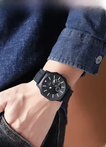 Detail of luminous dial and black silicone strap on a businessman's casual quartz watch