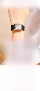 Detail of square rose gold watch with diamond bezel and quilted black leather strap