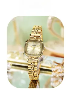 Macro detail of retro square gold-tone watch with champagne dial and five-link metal strap