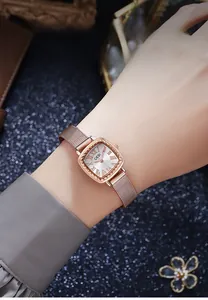 Close-up of rose gold Milanese strap and square roman numeral dial on elegant lady watch