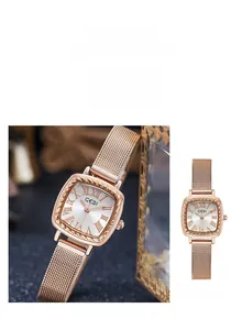 Detail of rose gold square watch featuring a rope-textured bezel and mesh steel strap