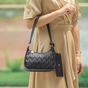 Chic black quilted shoulder bag set with gold hardware and small pouch accessory