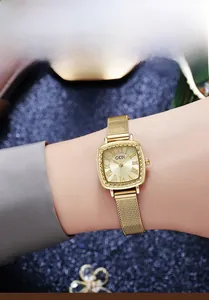 Close-up of vintage gold square dial with Roman numerals and Milanese mesh steel strap