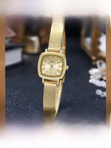 Detail of luxury gold square watch with roman numerals and Milanese mesh strap
