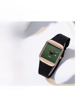Detailed close-up of a square rose gold watch case with a green dial and date display