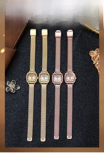 Close-up of vintage GEDI quartz watches with square dials and Milanese mesh bands