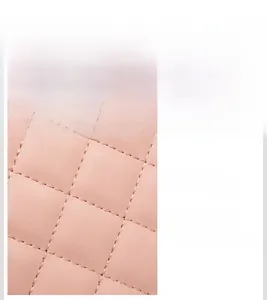Macro shot of pink diamond lattice quilted leather texture and fine stitching detail