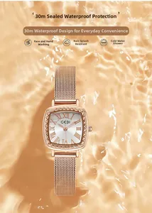 Detail of rose gold quartz watch with mesh band over water ripple background