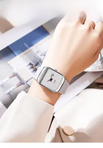 Close-up of minimalist square quartz watch with grey leather strap and date display