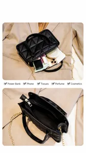 Internal view of black quilted mini bag showing storage capacity for phone and makeup