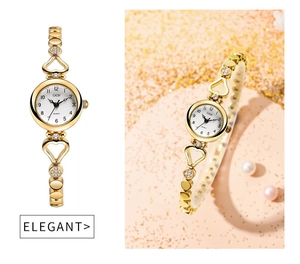 Detail of elegant gold alloy watch with heart-shaped links and diamond-encrusted bracelet