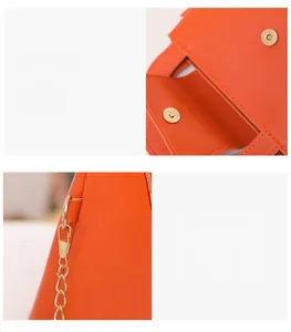 Détail du mini sac en cuir orange avec fermoir magnétique et finitions métalliques dorées