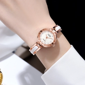 Elegant women's quartz watch with pearl dial and rose gold ceramic bracelet on wrist
