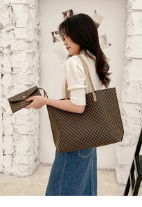 Detailed view of large brown geometric pattern tote bag and matching clutch pouch set