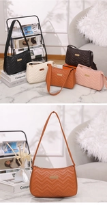 Detail showing V-shaped quilted wave pattern and rectangular gold metal plate on bags