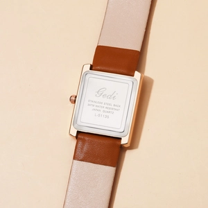 Detail of square quartz watch case back with stainless steel and leather strap