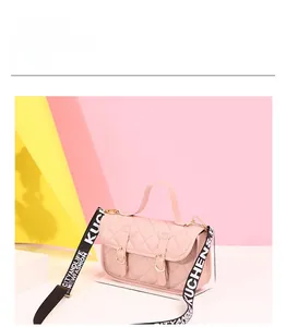 Pink quilted crossbody bag with letter print strap and 21x14x7cm size details