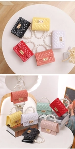 Detailed view of mini silicone jelly bags with pearl handles and quilted texture