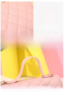 Detail of pink quilted texture fabric and soft handle on the elegant ladies handbag