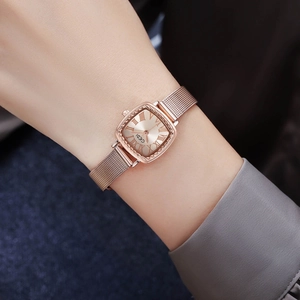 Elegant rose gold square quartz watch for women with mesh band on a model wrist