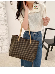 Lifestyle view showing the scale of the large tote bag with brown geometric patterns
