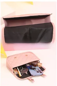 Pink quilted crossbody bag interior view showing storage space for phone and makeup