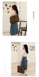 Detail view of large tote bag with vintage pattern and brown leather straps
