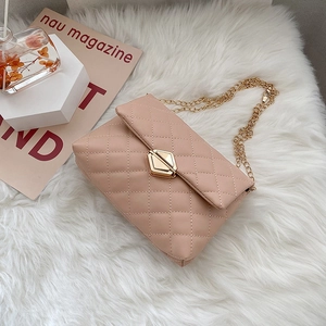 Quilted light pink crossbody bag with gold hexagonal lock and metal chain strap