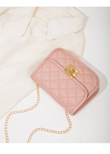Close-up of pink quilted small square bag with gold twist lock and chain strap