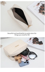 Detail of cream-white quilted bag showing interior space and makeup storage capacity