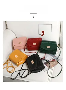 Detail of crocodile pattern mini square bags in pink red green yellow and black