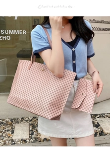 Pink vintage tote bag with matching snap pouch featuring geometric monogram pattern