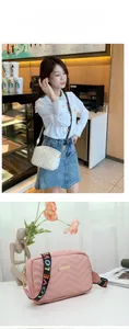 Detail of V-quilted crossbody bag with LOVE embroidered wide strap in white and pink