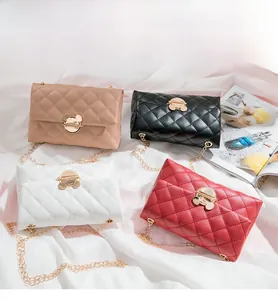 Close-up of quilted crossbody bags with golden Mickey-shaped twist locks and chain straps