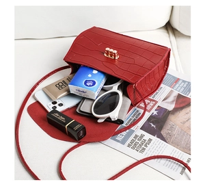 Internal view of a red crocodile pattern bag showing phone, lipstick and wallet space