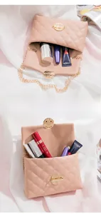 Detailed interior view of a pink quilted crossbody bag storing various cosmetics