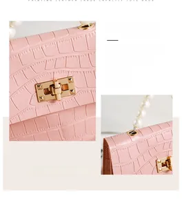 Details der rosa Tasche mit Kroko-Muster, Perlengriff und goldenem Drehverschluss