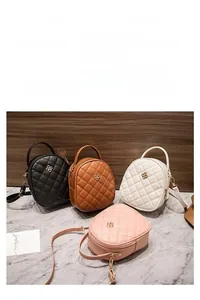 Detail of four colorful quilted crossbody bags with gold hardware and embroidery