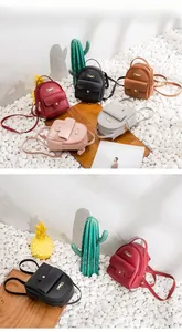 Mini faux leather backpacks in multiple colors with gold logo and front pockets