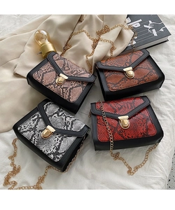 Detail showing various snake print crossbody bags with golden chain straps and locks