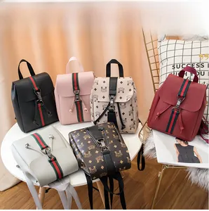 Detailed view of fashionable mini backpacks in diverse colors and retro patterned PU leather