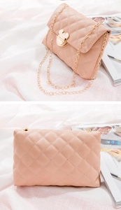 Detail of pink quilted crossbody bag featuring a golden Mickey mouse metal buckle and chain