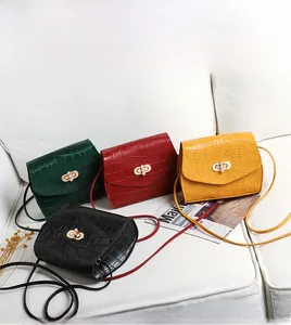 Close-up of crocodile pattern mini bags with pearl clasp in black, green, red and yellow